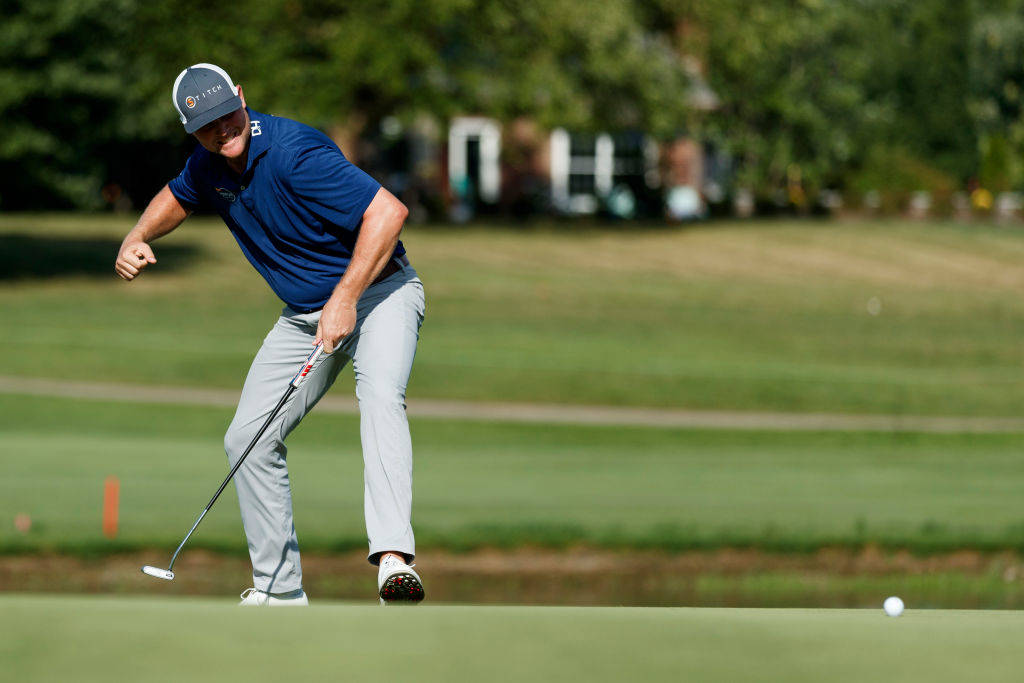 Trey Mullinax celebrates holing the winning putt